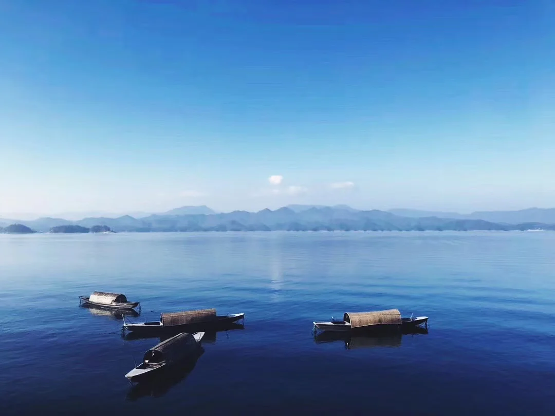 Small fishing boats resting on calm water at Erhai Lake