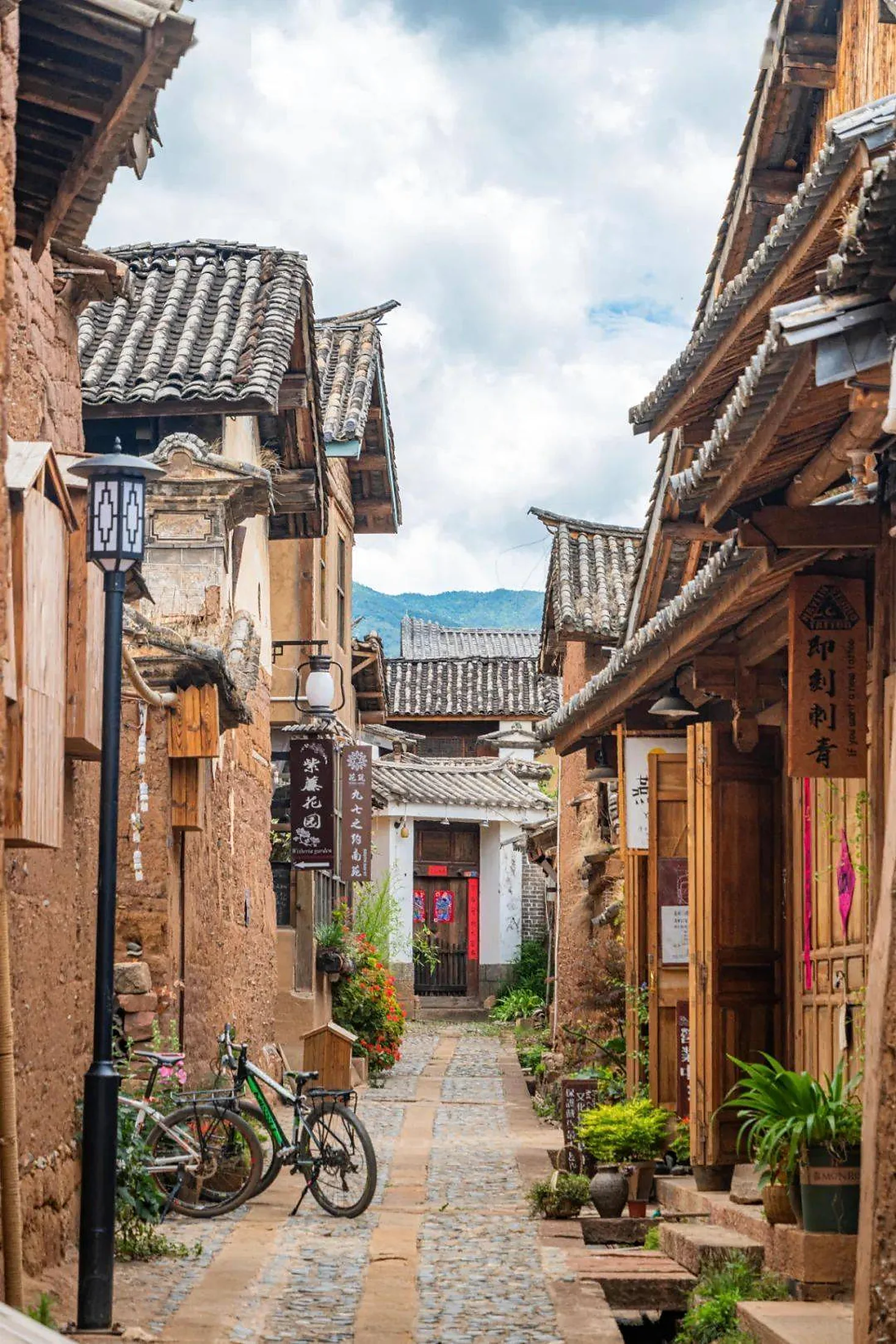 A narrow stone lane lined with traditional homes in Shaxi Ancient Town