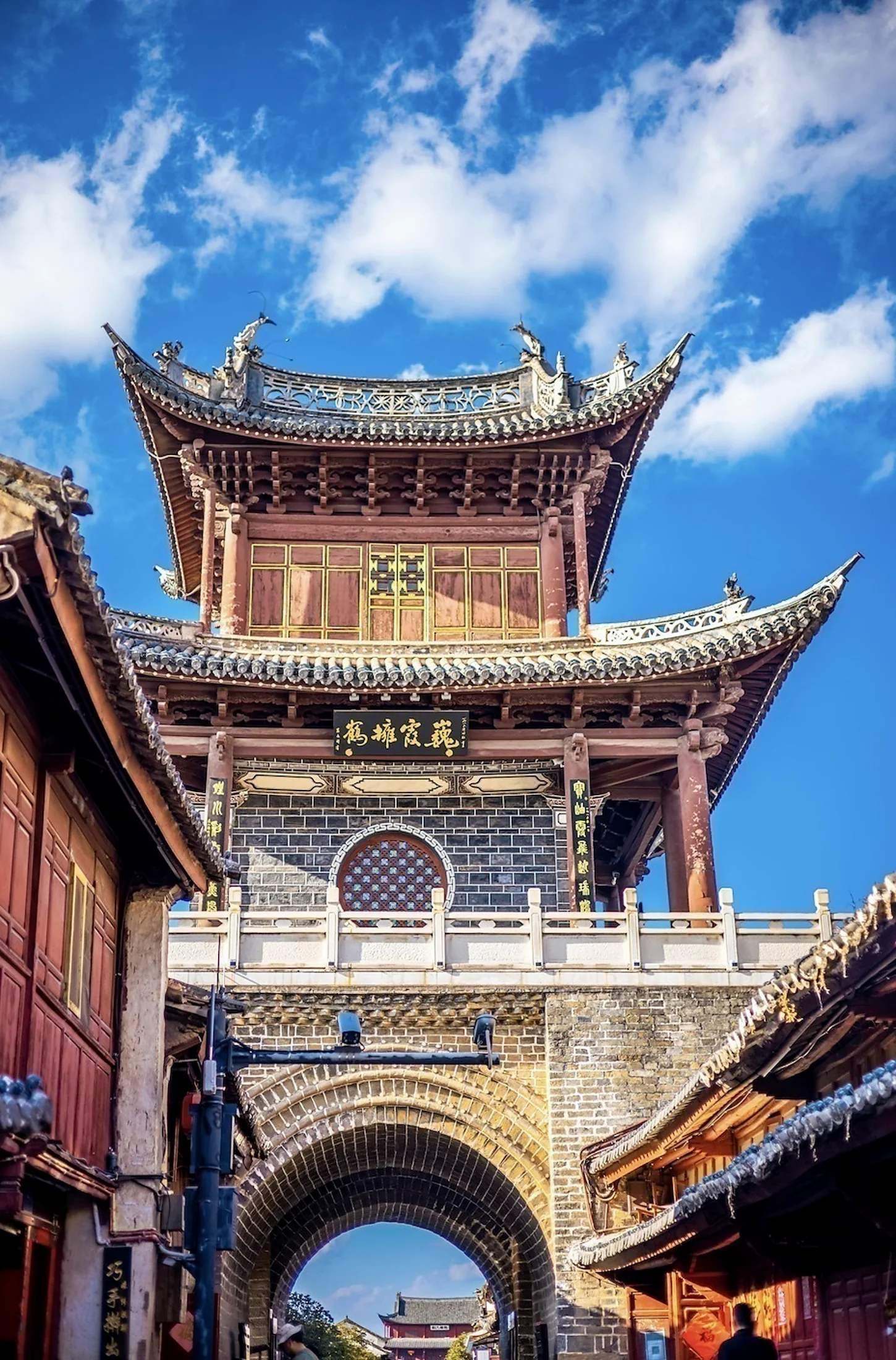 Historic gate tower above a street in Weishan Ancient Town