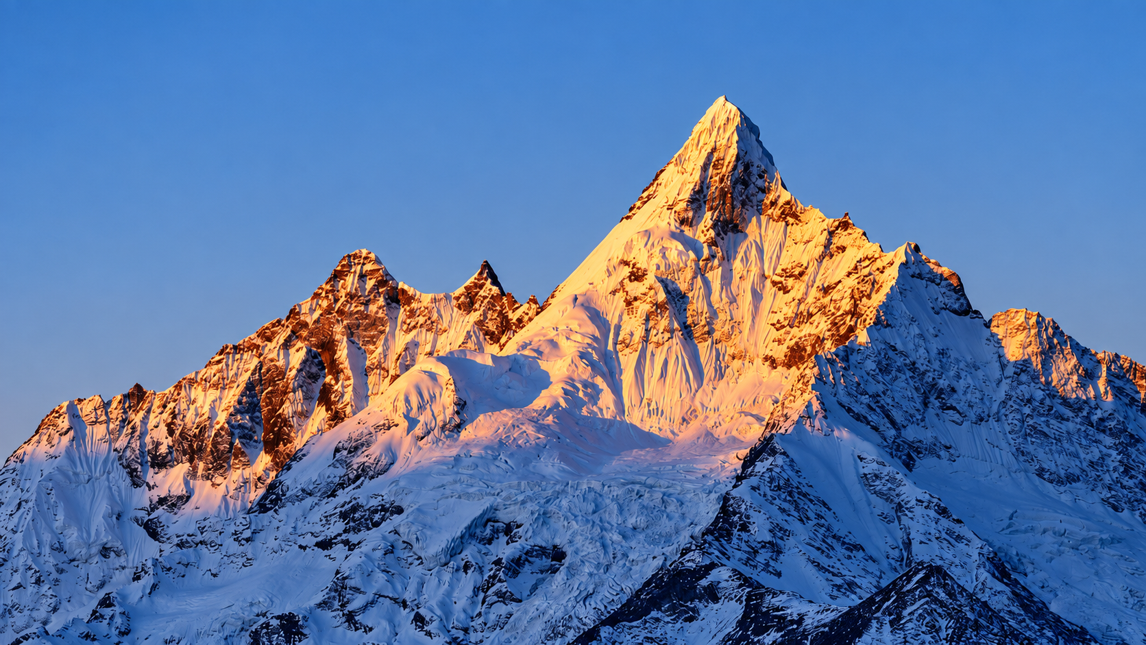 Sunrise light on a snow-covered peak of Meili Snow Mountain